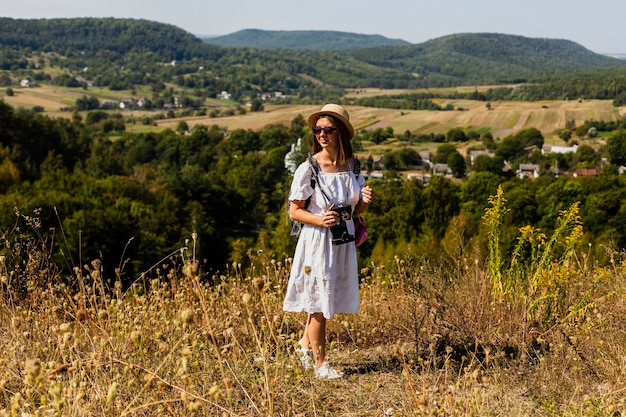 Free photo long shot of woman looking away with natural landscape