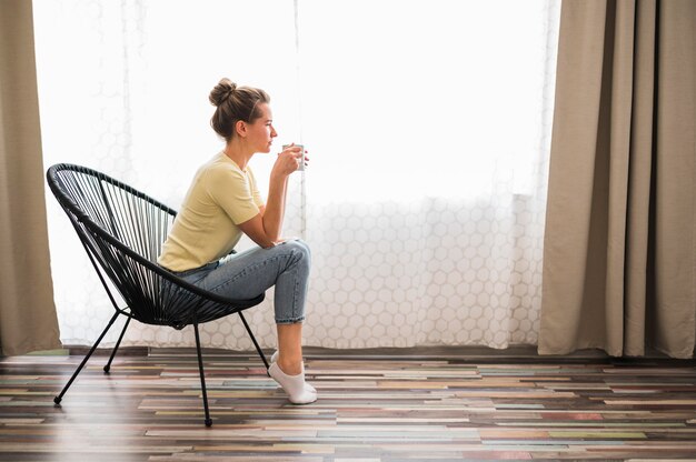 Long shot of woman sitting on chair