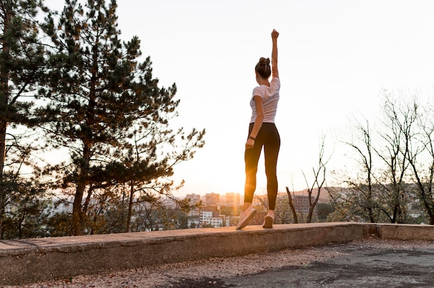 Free Photo long shot woman in sportswear being victorious