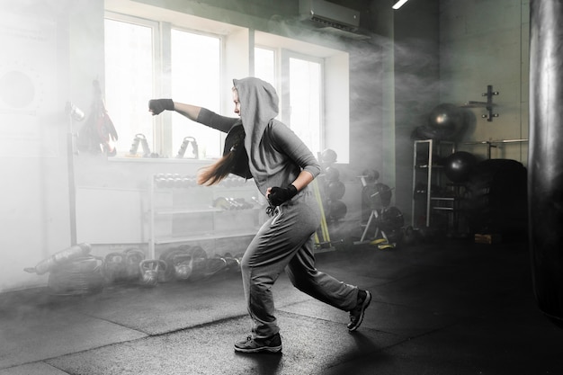 Free Photo long shot woman training in boxing center