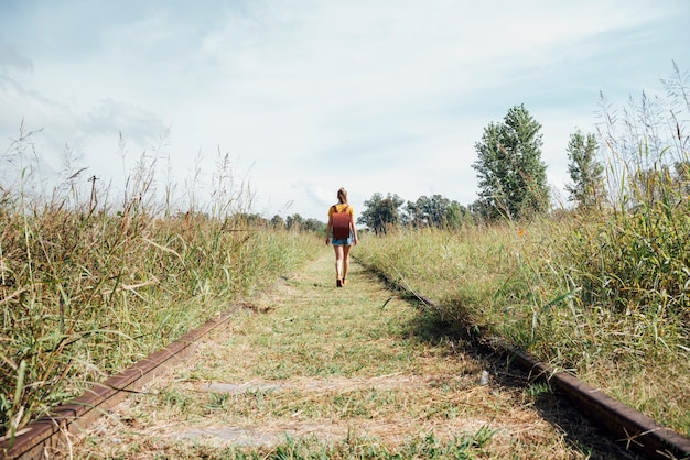 Free Photo long shot of woman walking on railway