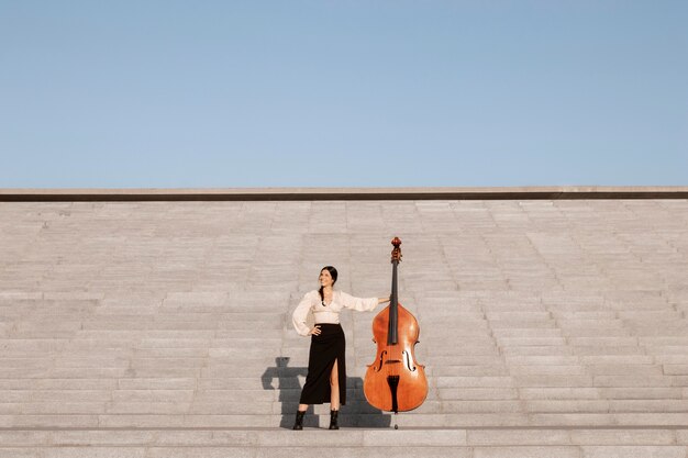 Long shot woman with double bass