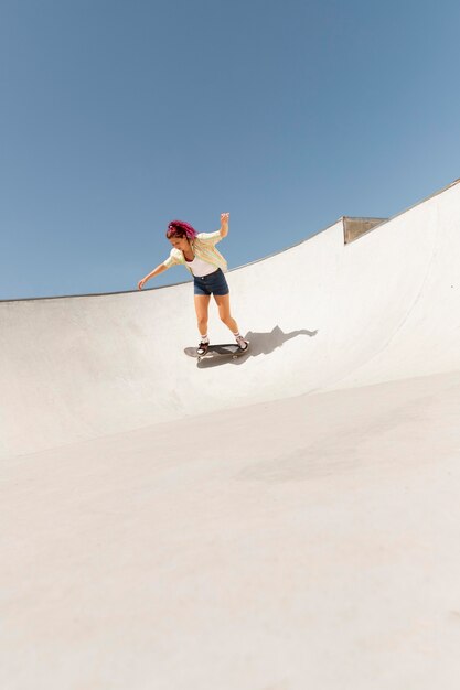 Long shot woman with skateboard