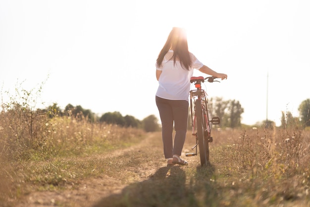 Long shot of a young man and a bicycle