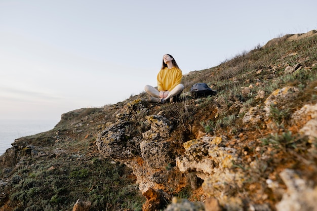 Free photo long shot of young woman enjoying the nature around her