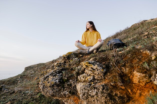 Long shot of young woman enjoying the nature around her