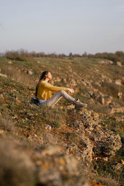 Long shot of young woman enjoying the nature around her