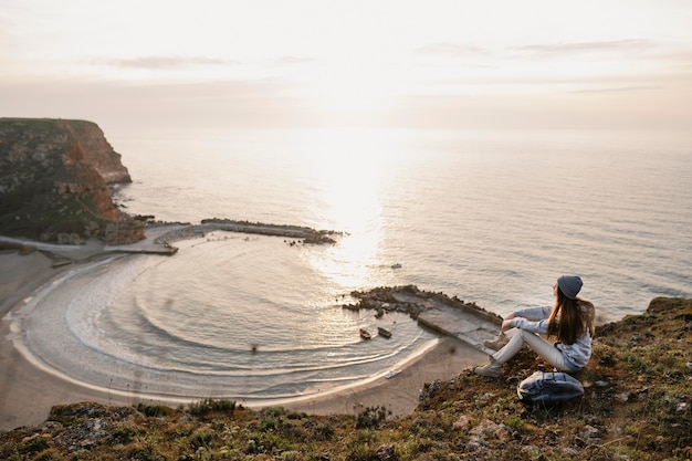 Free photo long shot of young woman enjoying the peace around her