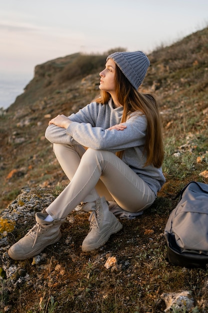 Long shot of young woman enjoying the peace around her