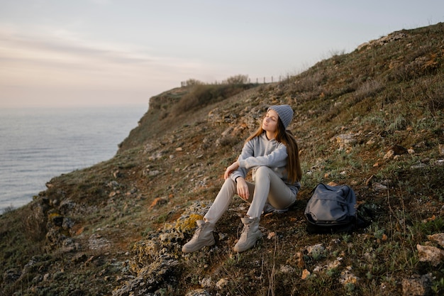 Free Photo long shot of young woman enjoying the peace around her