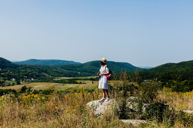 Long view shot of woman in white dress