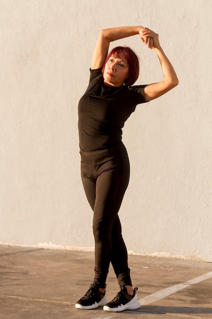 Long view woman stretching her back