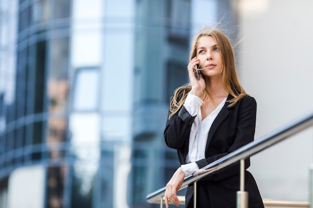 Free photo looking away woman talking on the phone