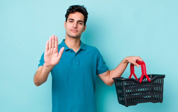 Looking serious showing open palm making stop gesture