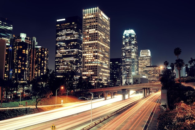 Free photo los angeles downtown at night with urban buildings and light trail