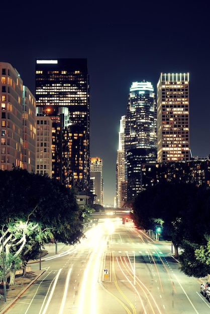 Free photo los angeles downtown at night with urban buildings and light trail