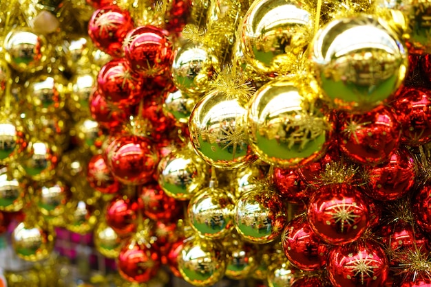 Free Photo a lot of christmas glass red and yellow balls are hanging in the store. festive new year decor