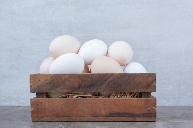 Free photo a lot of fresh chicken white eggs on basket. high quality photo