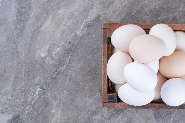 A lot of fresh chicken white eggs on basket. High quality photo