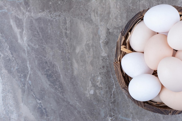 A lot of fresh chicken white eggs on basket. High quality photo