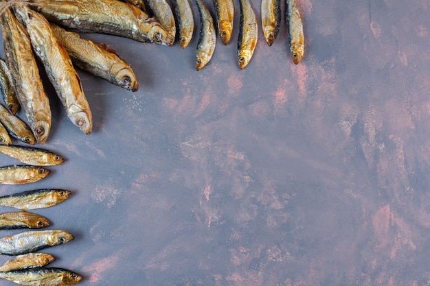 Free photo lots of dried salted fish on the marble surface