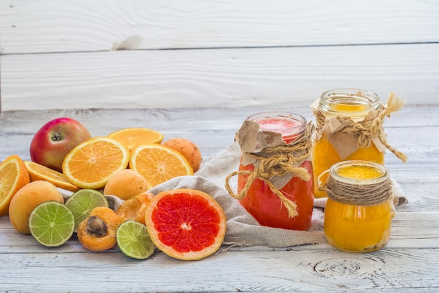 lots of fresh fruit, cut on a beautiful wooden background, fresh fruit drink, jam, tasty, healthy food