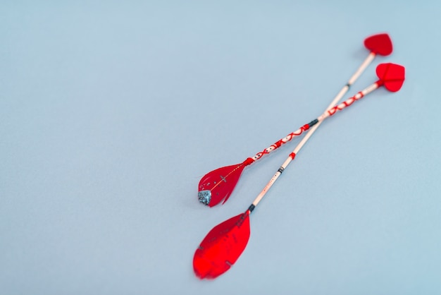 Love arrows on blue table