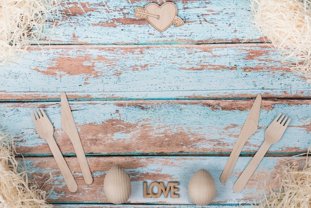 Love inscription with cutlery set on table