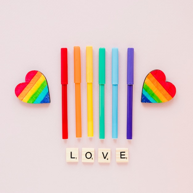 Free Photo love inscription with rainbow hearts and felt pens