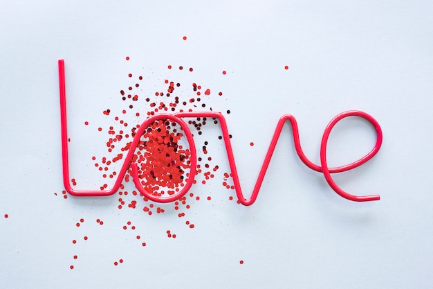 Love inscription with spangles on table 