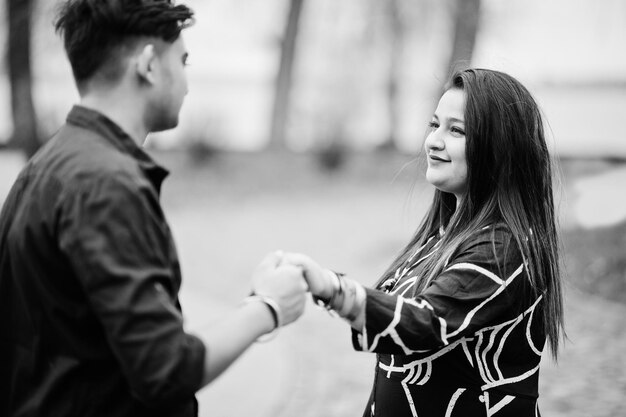 Love story of indian couple posed outdoor holding hands together