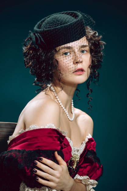 Free photo love tragic. young woman as anna karenina isolated on dark blue