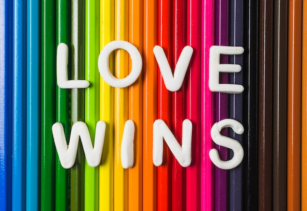 Free photo love wins words and lgbt flag of pencils