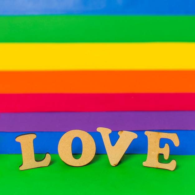 Free Photo love wooden word and lgbt flag