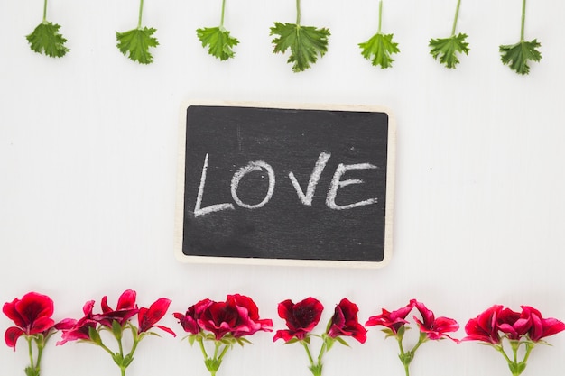 Free Photo love word on blackboard in flowers