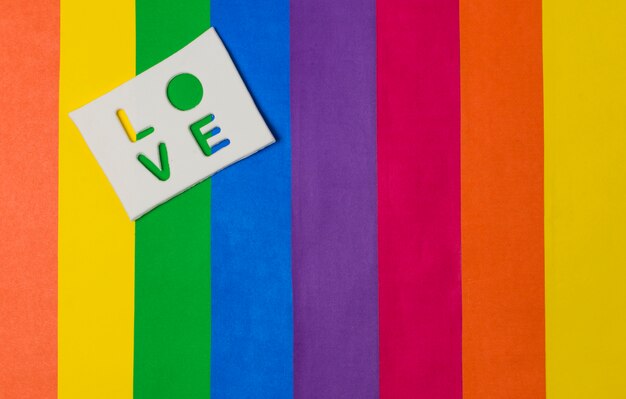 Love word on tablet and bright LGBT flag