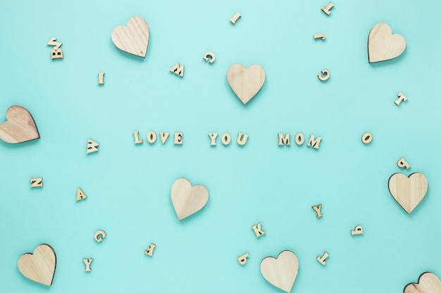 Free Photo love you mom inscription with wooden hearts 