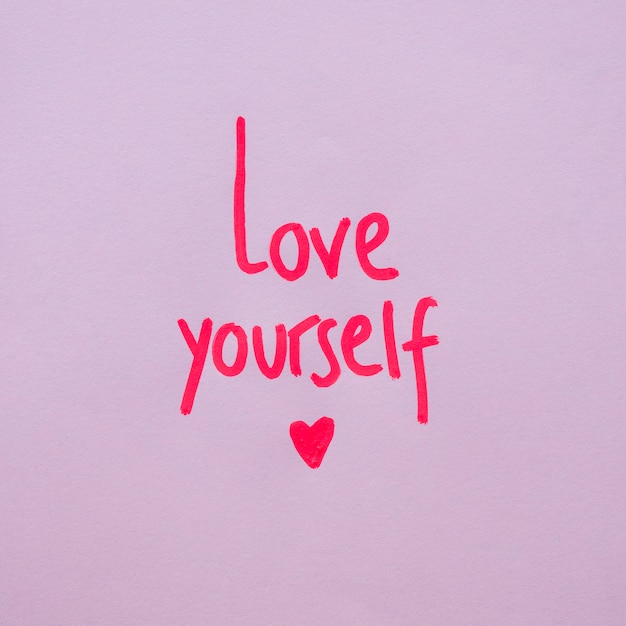 Free photo love yourself inscription on purple background