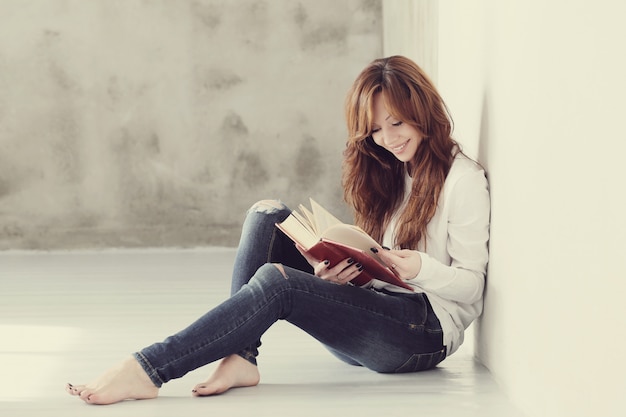 Lovely and charming adult woman reading book