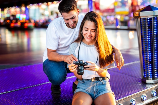 Free Photo lovely couple at fair looking at camera