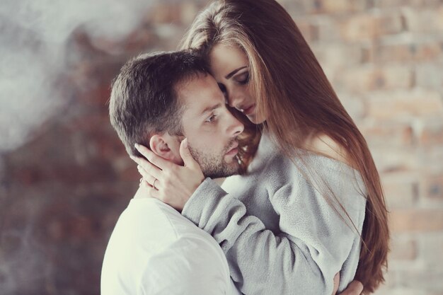 Lovely couple hugging at home