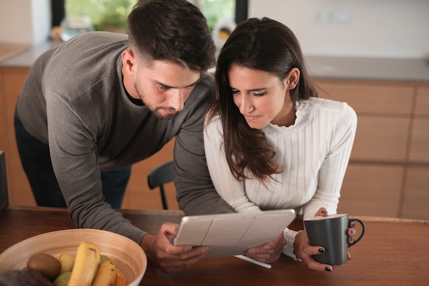 Lovely couple looking at tablet