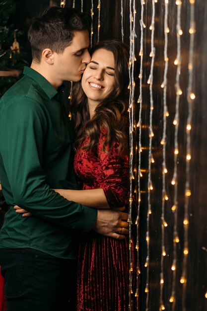 The lovely couple in love embracing near lamps