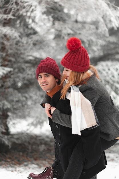 Free photo lovely couple playing outdoors in the winter