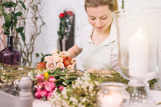 Lovely florist at table in flower shop