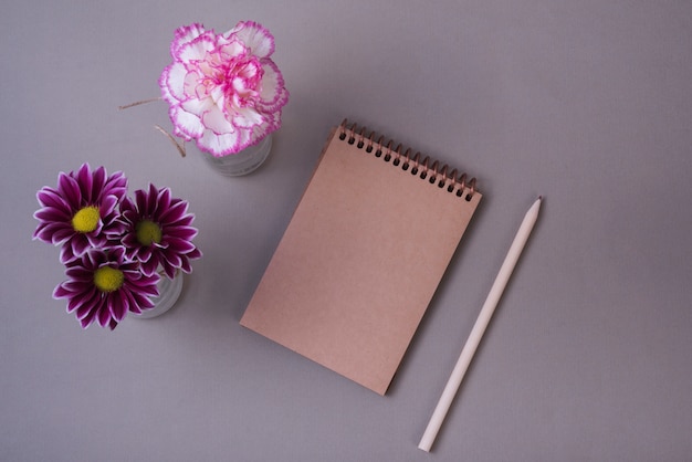 Lovely flowers concept with modern notebook