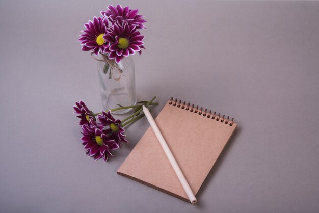 Lovely flowers concept with notebook