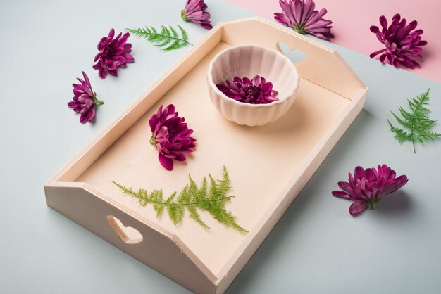 Lovely flowers concept with wooden tray