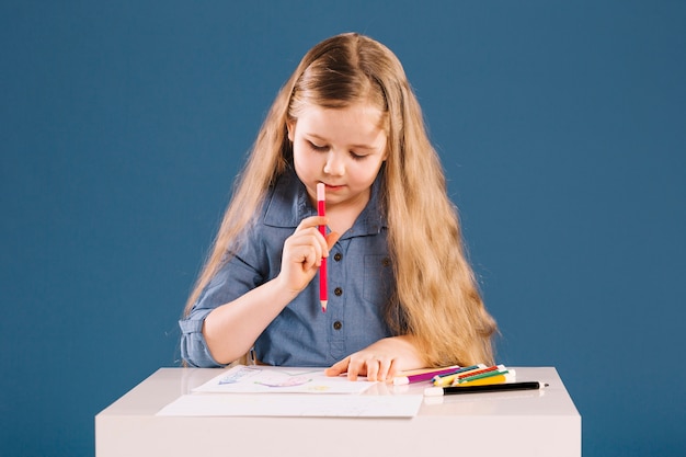 Free photo lovely girl drawing at table