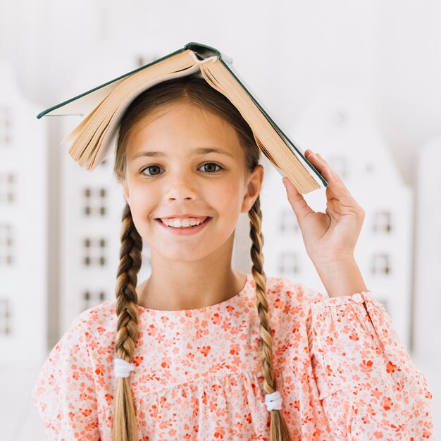 Lovely happy girl posing with a book